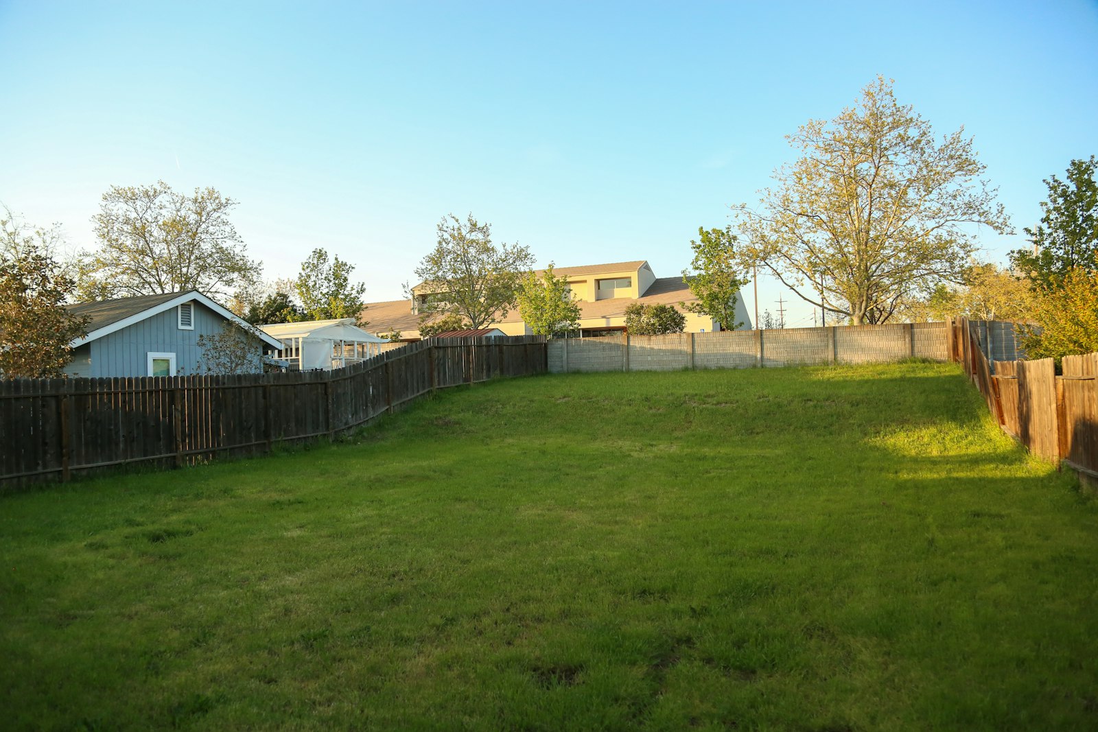 Grassy vacant lot between neighboring homes